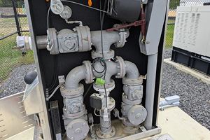 Internal piping and valve setup within a wastewater pump station enclosure, showing important components used in wet well design